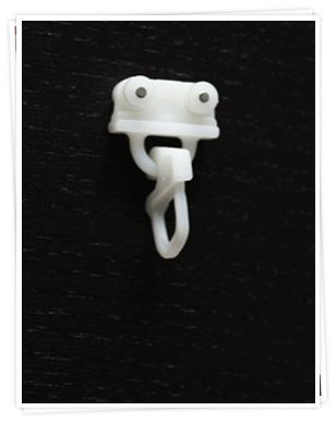 Glider with plastic curtain hook for a curtain track. Glider with plastic curtain hook for a curtain track.